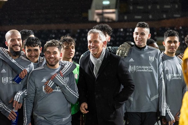 Gary Lineker with child refugees at Craven Cottage